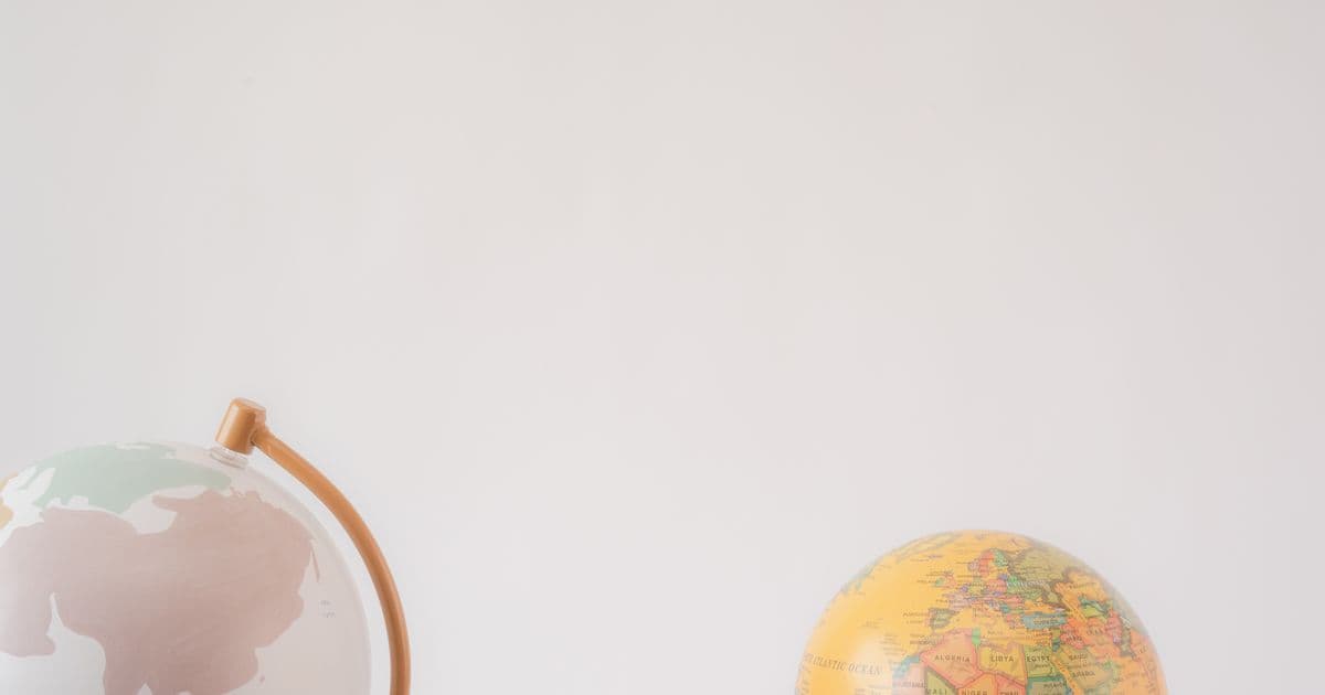Two decorative world globes side by side, representing gift-giving traditions around the world